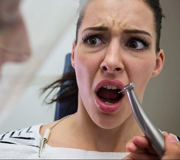 Young woman scared during a dental check-up at clinic