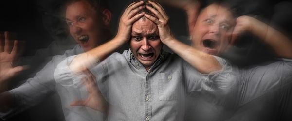 Man having panic attack on dark background